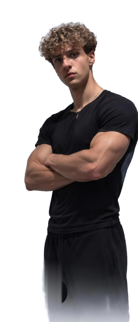 Marko, arms crossed, in a black t-shirt in a grey studio